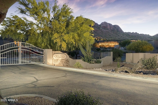 gate at dusk with a mountain view