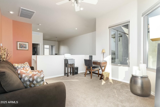 carpeted living room with ceiling fan