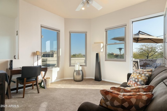 interior space with ceiling fan, light colored carpet, and a healthy amount of sunlight