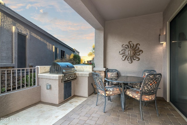 patio terrace at dusk with area for grilling and grilling area