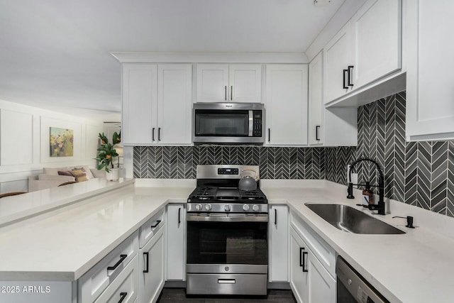 kitchen with white cabinets, stainless steel appliances, and light countertops