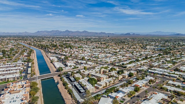 drone / aerial view featuring a mountain view and a city view