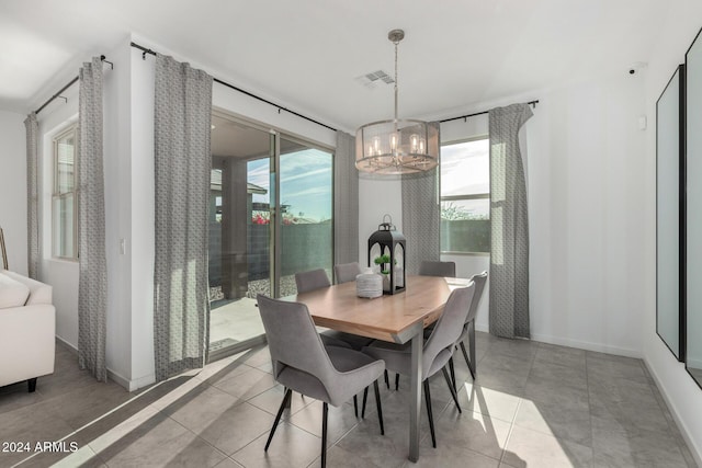 dining room featuring light tile patterned floors and a notable chandelier