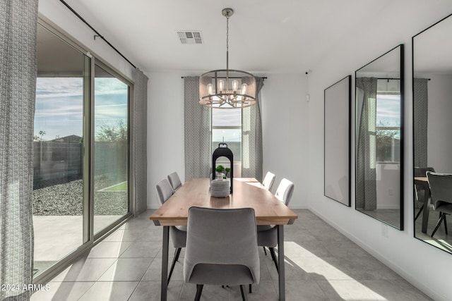 dining room with a notable chandelier and light tile patterned floors