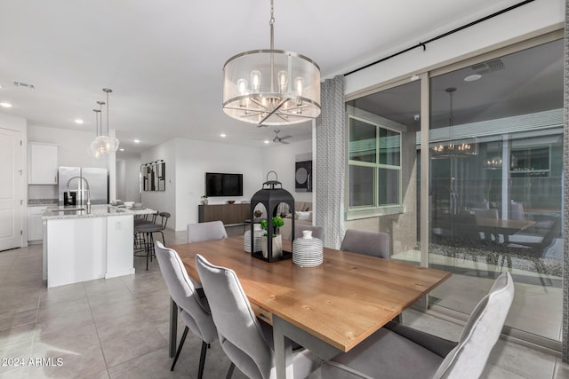 tiled dining room with an inviting chandelier