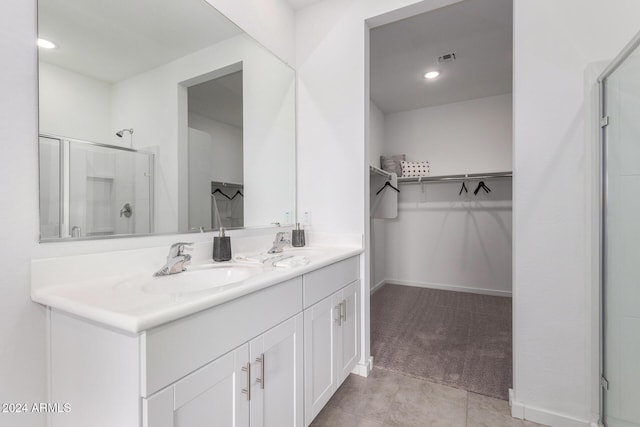 bathroom featuring vanity, tile patterned floors, and a shower with shower door