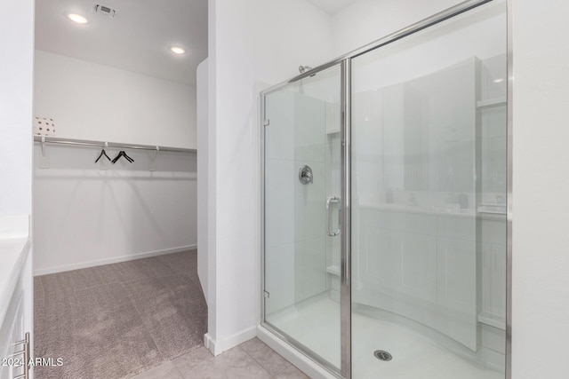 bathroom featuring tile patterned floors and a shower with door