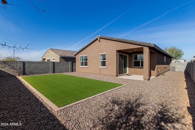 back of property with a patio