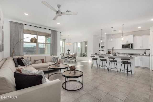 tiled living room featuring ceiling fan