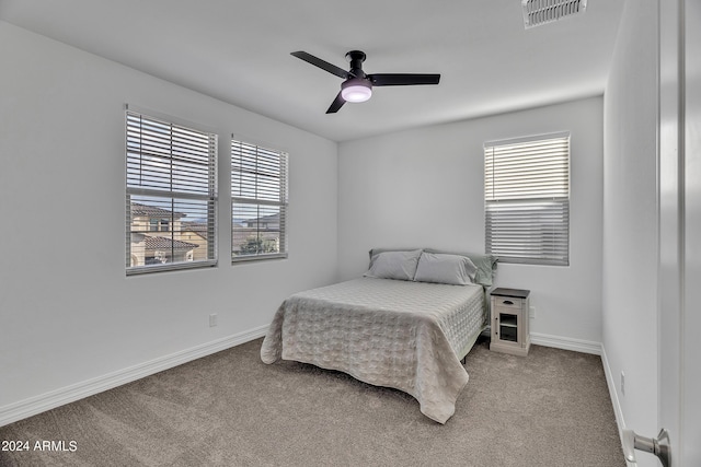 bedroom featuring ceiling fan, carpet flooring, and multiple windows