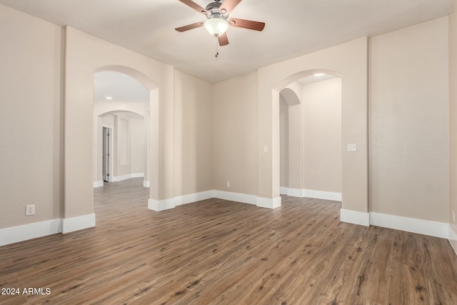 empty room featuring ceiling fan and dark wood-type flooring