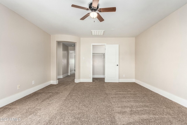 unfurnished bedroom with ceiling fan, a closet, and carpet floors