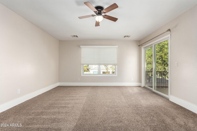 spare room featuring carpet flooring and ceiling fan