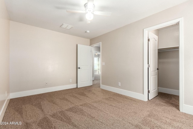 unfurnished bedroom with carpet, a closet, and ceiling fan