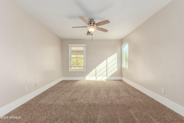 carpeted empty room featuring ceiling fan