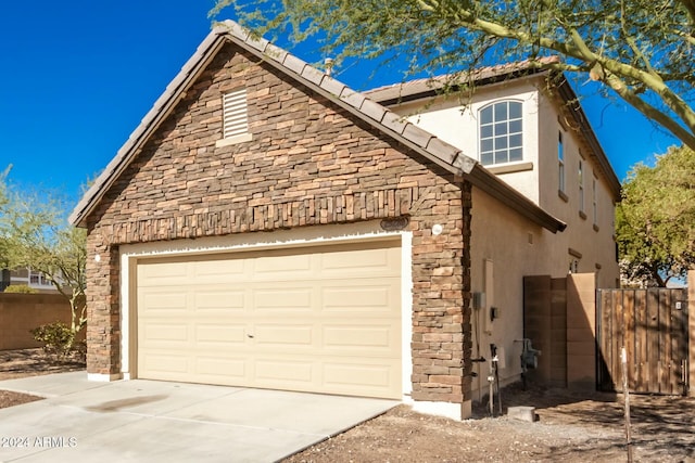 view of side of property with a garage