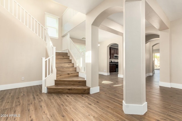 stairs with hardwood / wood-style floors