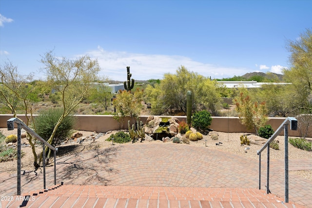 view of patio featuring fence