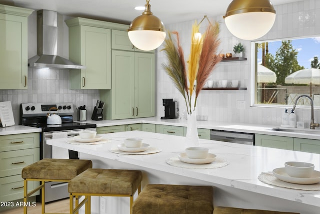 kitchen featuring wall chimney exhaust hood and green cabinets