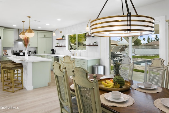 dining area featuring light hardwood / wood-style floors and an inviting chandelier