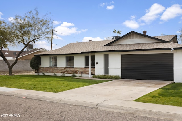 ranch-style home with a garage and a front lawn