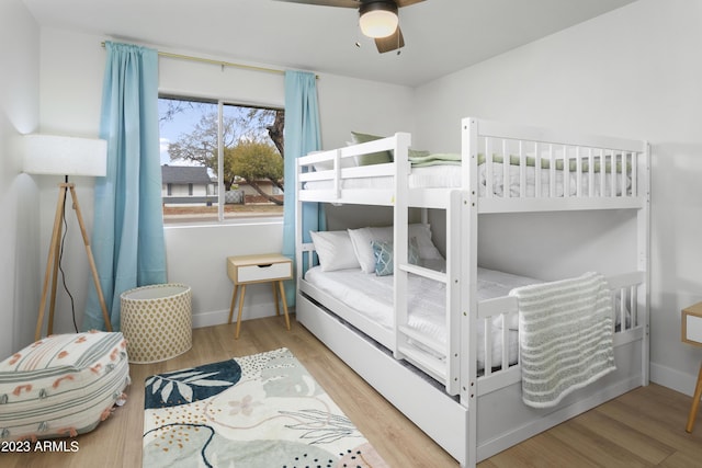 bedroom with ceiling fan and hardwood / wood-style flooring