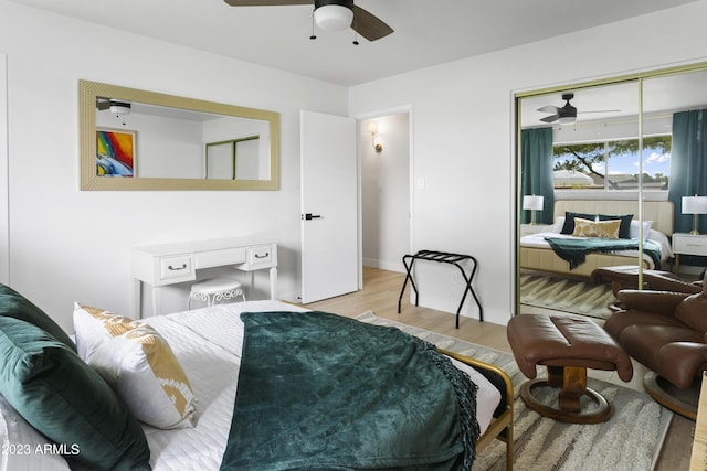 bedroom featuring ceiling fan, a closet, and light hardwood / wood-style floors