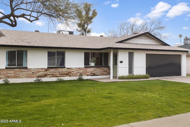 ranch-style house featuring a front yard and a garage