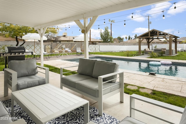 view of patio featuring outdoor lounge area, a gazebo, a fenced in pool, and area for grilling