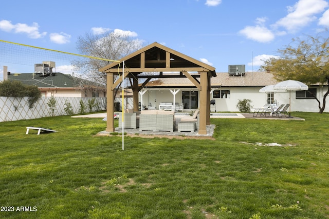 back of property featuring outdoor lounge area, a gazebo, a patio area, and a lawn