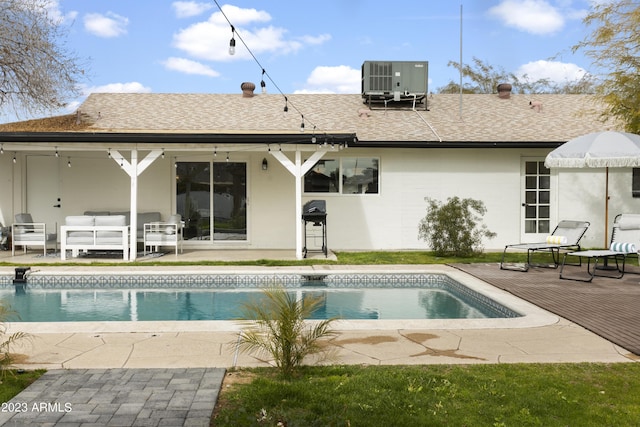 back of property with an outdoor hangout area, a patio area, and central AC unit