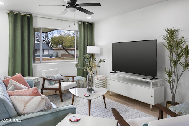 living room with ceiling fan and hardwood / wood-style floors