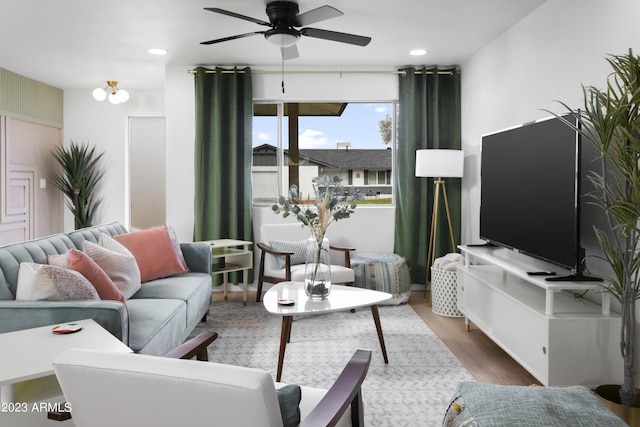 living room with hardwood / wood-style flooring and ceiling fan