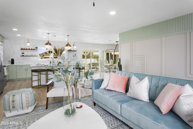 living room featuring light wood-type flooring and bar