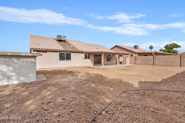 rear view of property with cooling unit