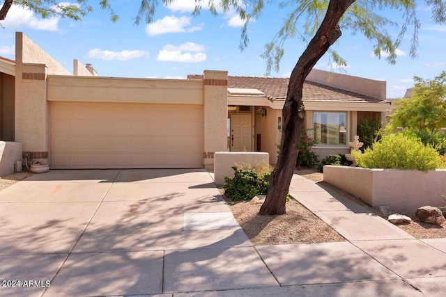 adobe home featuring a garage