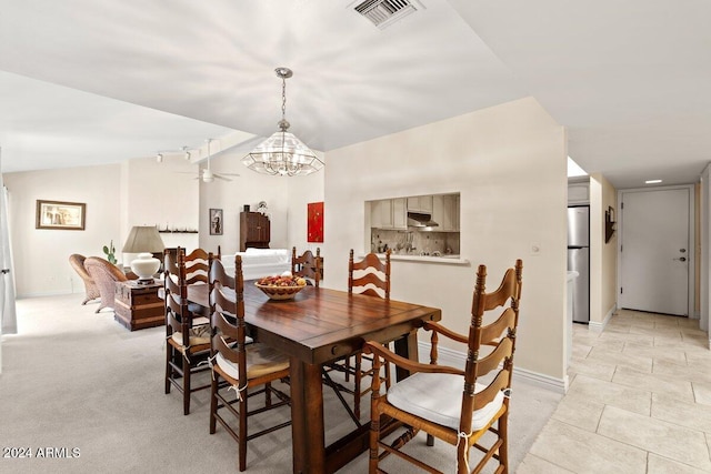 tiled dining area featuring lofted ceiling and ceiling fan with notable chandelier