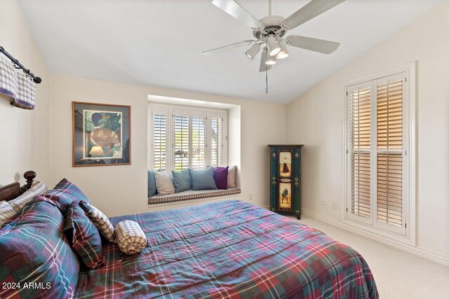 carpeted bedroom with vaulted ceiling and ceiling fan