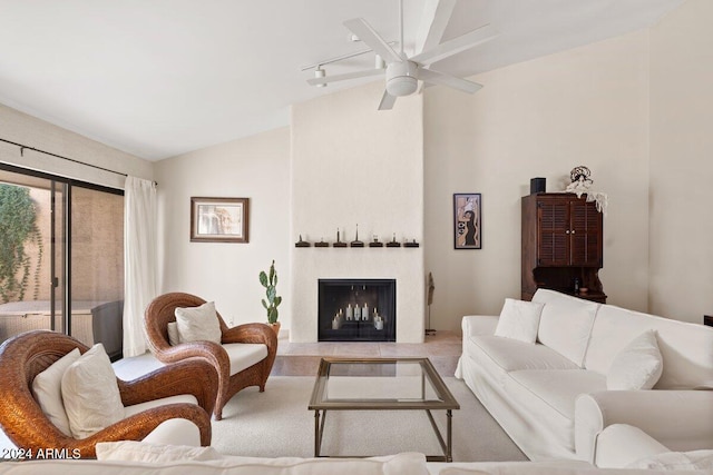 living room with ceiling fan and vaulted ceiling