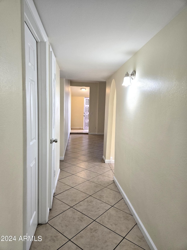 hall with light tile patterned flooring