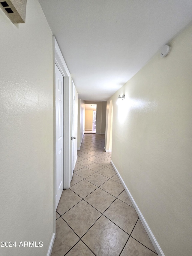 hall with light tile patterned floors