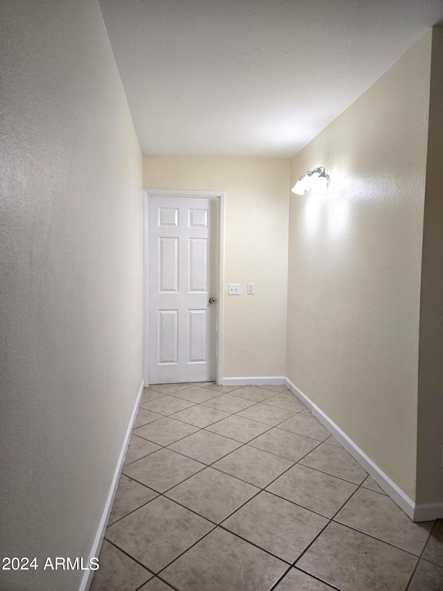 corridor with light tile patterned floors