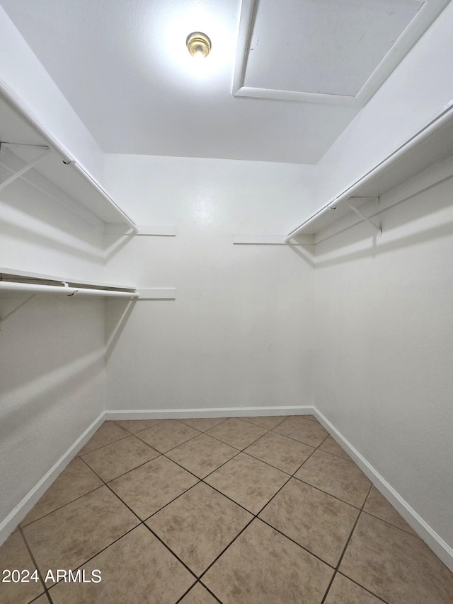 walk in closet featuring tile patterned flooring