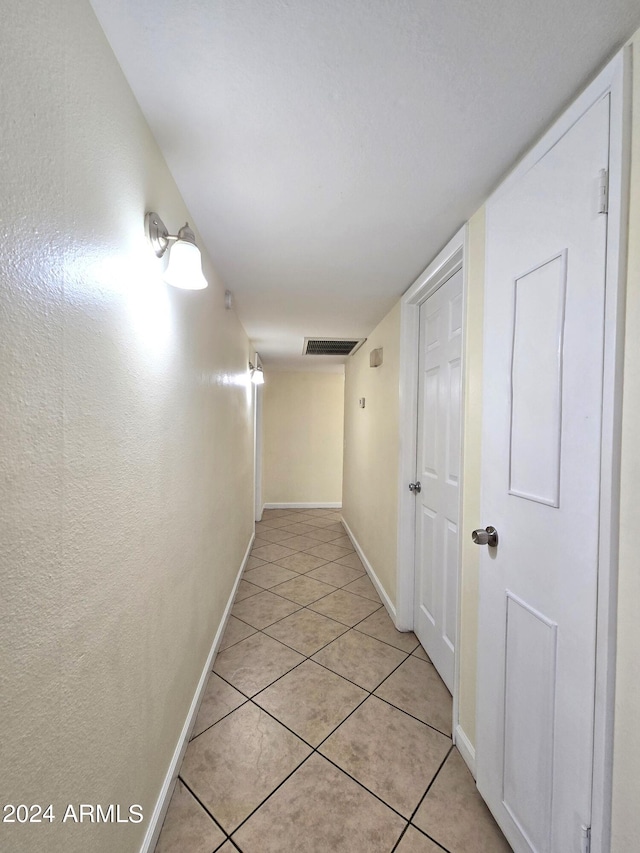 corridor with light tile patterned floors