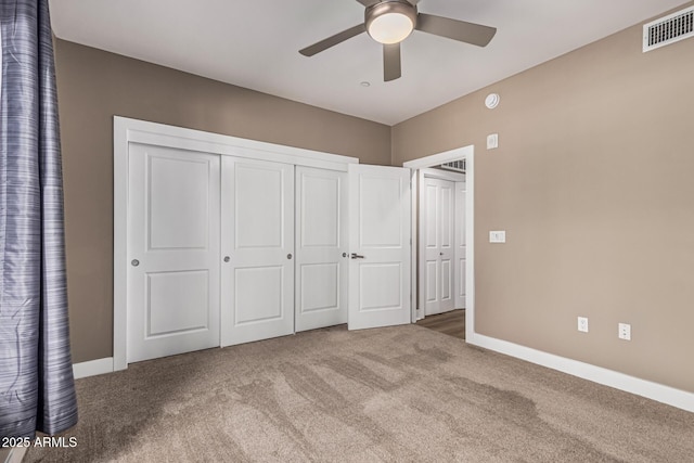 4805 N Woodmere Fairway Unit 1002, Scottsdale, AZ 85251 - unfurnished bedroom featuring carpet, a closet, and ceiling fan