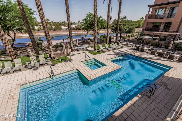 4805 N Woodmere Fairway Unit 1002, Scottsdale, AZ 85251 - community pool with a hot tub, a patio, and a water view