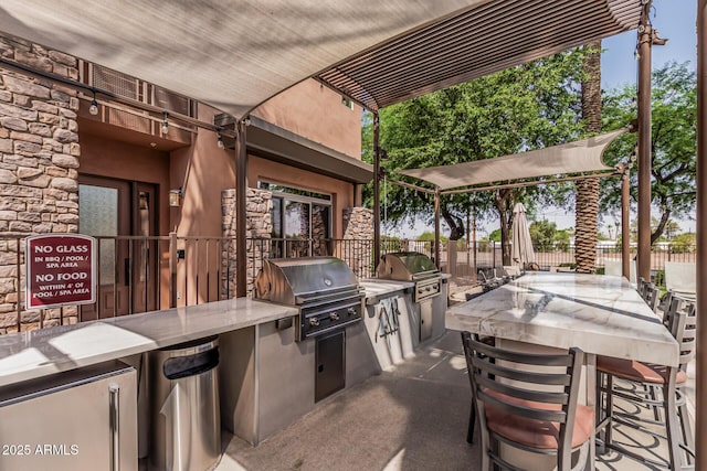 4805 N Woodmere Fairway Unit 1002, Scottsdale, AZ 85251 - view of patio with area for grilling and exterior bar