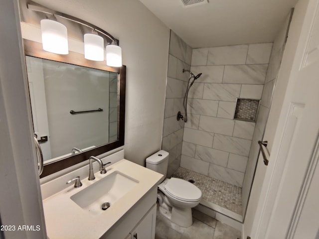 3208 W Bloomfield Rd, Phoenix, AZ 85029 - full bathroom with toilet, vanity, tiled shower, and tile patterned flooring