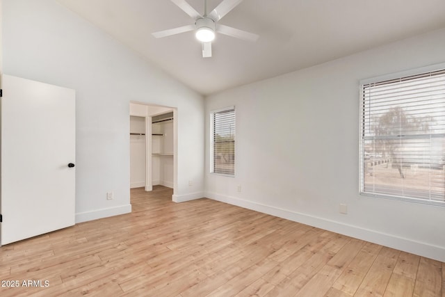 unfurnished bedroom with baseboards, light wood finished floors, vaulted ceiling, and ceiling fan