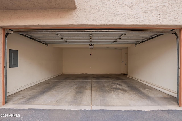 garage with electric panel and a garage door opener